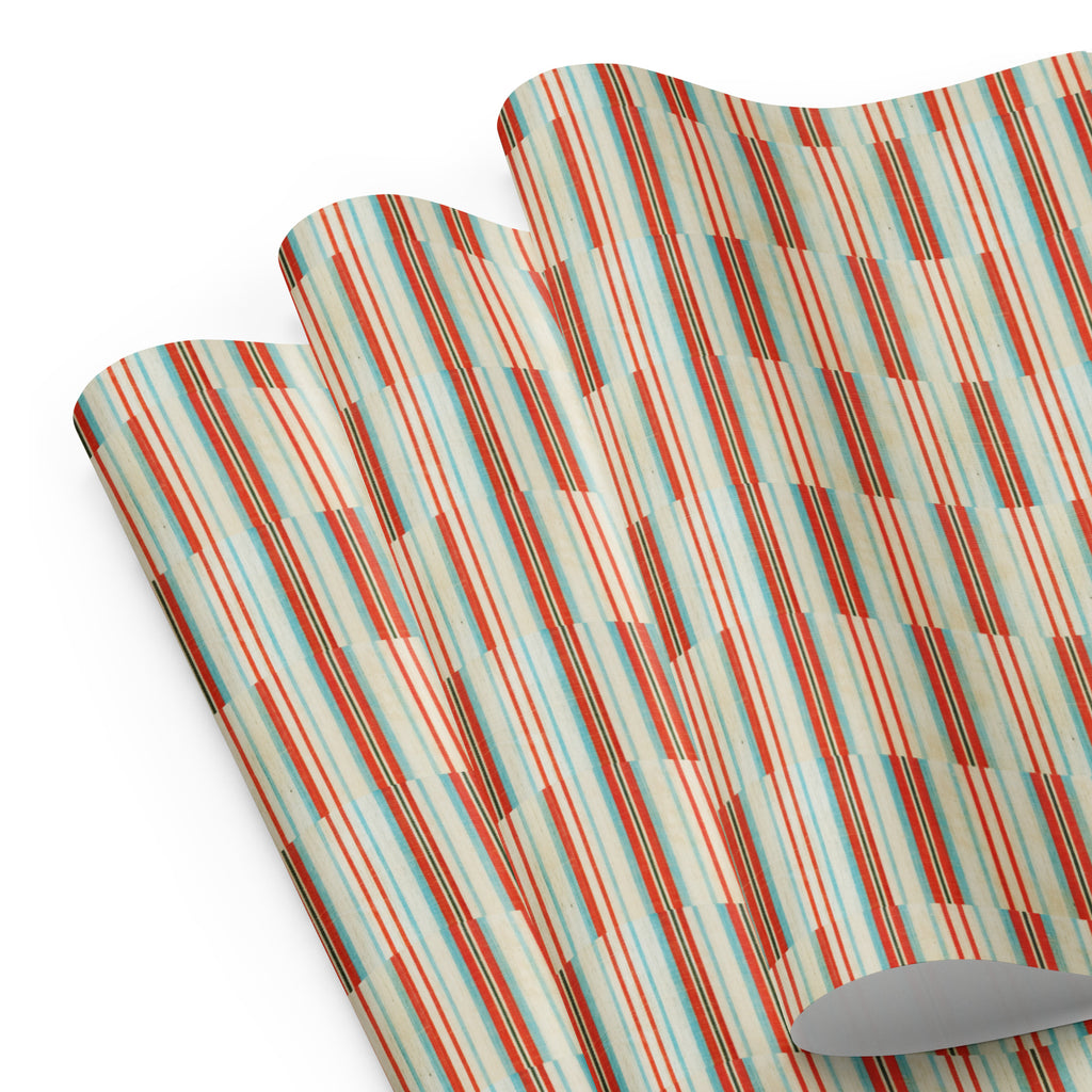 Two colorful plaid placemats with a knife on a white background